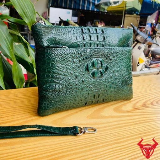 Clutch da cá sấu gù nguyên khối màu xanh lá đậm chất thời trang quý ông.