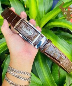 Mặt khóa trắng vàng sang trọng trên nền da cá sấu nâu đậm.