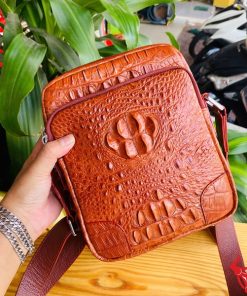 Hình ảnh túi đeo chéo nam da cá sấu nâu đỏ, bền bỉ, sang trọng, đẳng cấp thời trang.